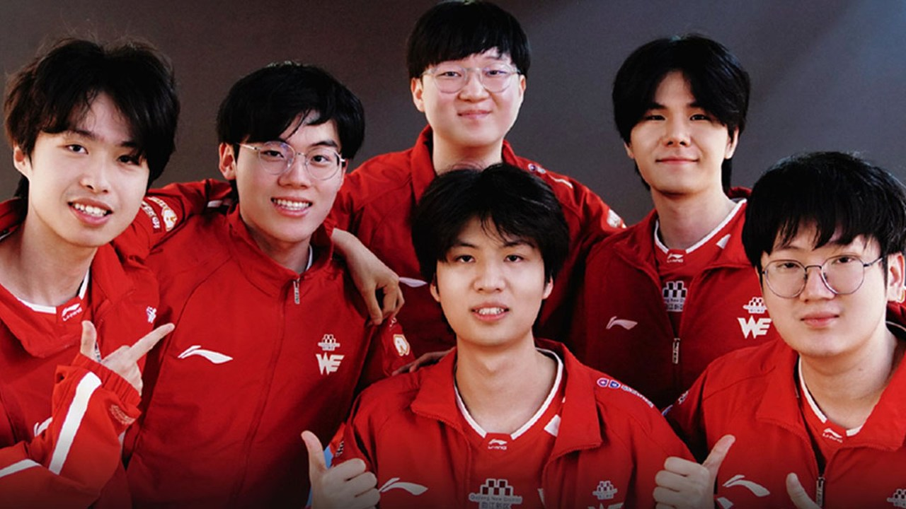 Team WE League of Legends players pose together in red shirts